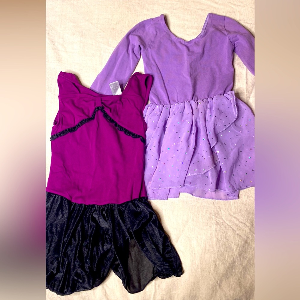2 girls dance leotards purple with skirts. Size 10-12. Long sleeve and sleeveles